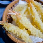A delicious and crispy shrimp tempura served in a traditional basket, showcasing Japanese cuisine.